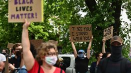 defund Protesters hold up signs on June 3, 2020