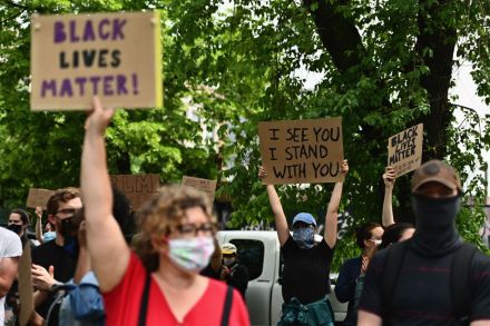defund Protesters hold up signs on June 3, 2020