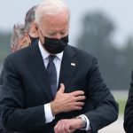 grief President Joe Biden looks down at his watch (Getty Images)