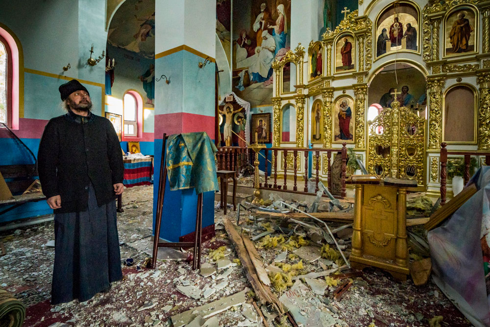 A priest of Yasnohorodka, inside his destroyed church on the outskirts of Kyiv