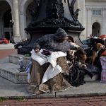 A woman sits with her dogs outside Union Station March 22, 2016 in Washington, DC (BRENDAN SMIALOWSKI/AFP via Getty Images)