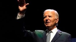 US President Joe Biden waves on stage (Photo by KENT NISHIMURA/AFP via Getty Images)