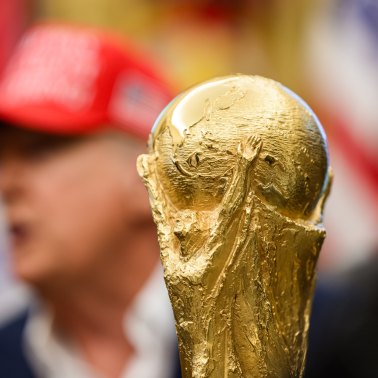 The soccer World Cup trophy sits in front of President Donald Trump