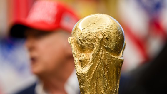 The soccer World Cup trophy sits in front of President Donald Trump