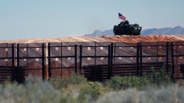 An eight-wheeled military vehicle patrols near the border wall which is being painted black after an order by US President Donald Trump, according to US Secretary of Homeland Security Kristi Noem, between Santa Teresa, New Mexico and Ciudad Juarez, Chihuahua, Mexico on August 28, 2025. 8 miles of metal barrier are under construction since July 15 in the El Paso Sector. (Photo by Herika Martinez / AFP)