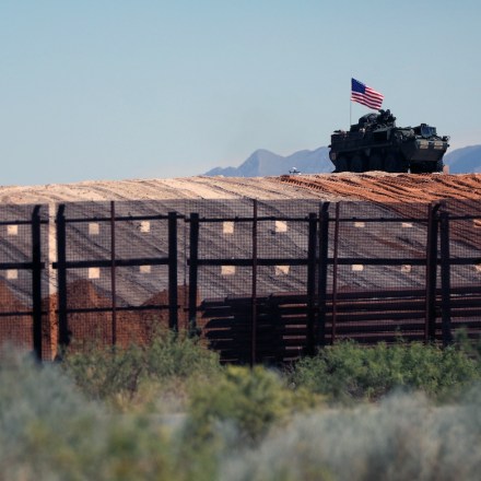 An eight-wheeled military vehicle patrols near the border wall which is being painted black after an order by US President Donald Trump, according to US Secretary of Homeland Security Kristi Noem, between Santa Teresa, New Mexico and Ciudad Juarez, Chihuahua, Mexico on August 28, 2025. 8 miles of metal barrier are under construction since July 15 in the El Paso Sector. (Photo by Herika Martinez / AFP)