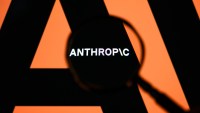 The Anthropic logo is displayed on a computer screen photographed through a magnifying glass in Creteil, France, on April 21, 2026. The image is taken amid reports of the NSA using Claude Mythos Preview despite a ban on Anthropic for United States government agencies. (Photo by Samuel Boivin/NurPhoto via Getty Images)