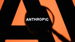 The Anthropic logo is displayed on a computer screen photographed through a magnifying glass in Creteil, France, on April 21, 2026. The image is taken amid reports of the NSA using Claude Mythos Preview despite a ban on Anthropic for United States government agencies. (Photo by Samuel Boivin/NurPhoto via Getty Images)