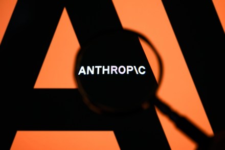 The Anthropic logo is displayed on a computer screen photographed through a magnifying glass in Creteil, France, on April 21, 2026. The image is taken amid reports of the NSA using Claude Mythos Preview despite a ban on Anthropic for United States government agencies. (Photo by Samuel Boivin/NurPhoto via Getty Images)