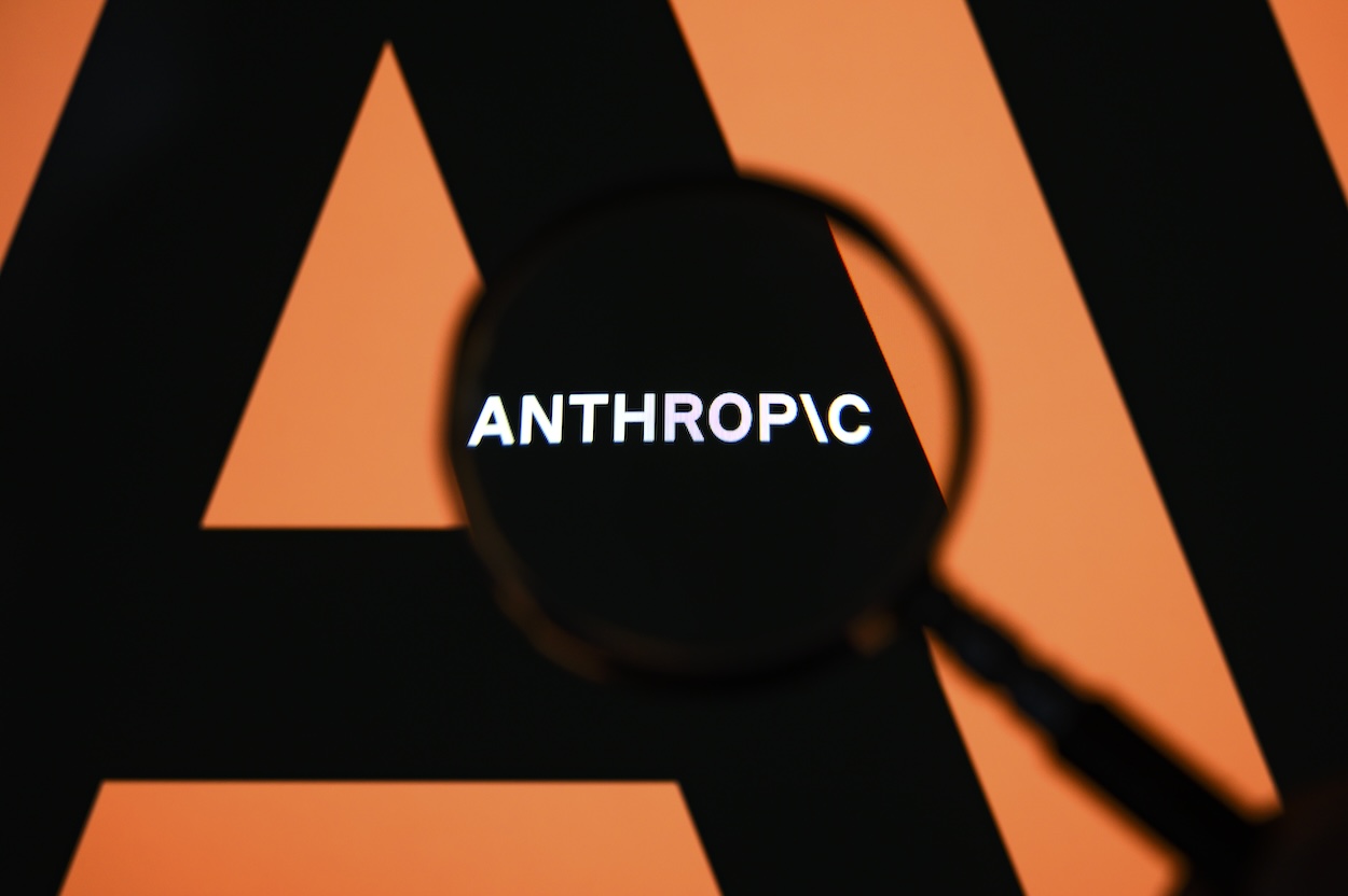 The Anthropic logo is displayed on a computer screen photographed through a magnifying glass in Creteil, France, on April 21, 2026. The image is taken amid reports of the NSA using Claude Mythos Preview despite a ban on Anthropic for United States government agencies. (Photo by Samuel Boivin/NurPhoto via Getty Images)